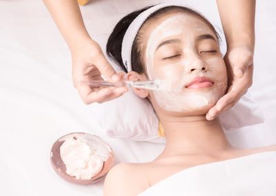 Young girl with facial mask at beauty salon